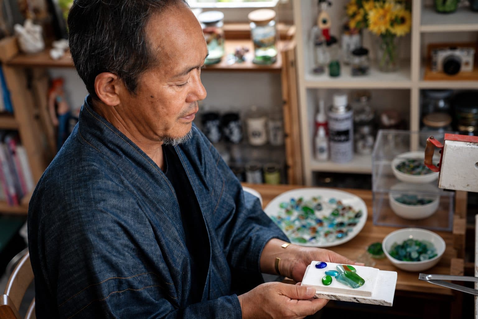 Artisan holding fired glass